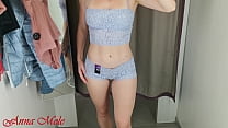 A girl with a perfect figure in a fitting room trying on different beautiful lingerie.